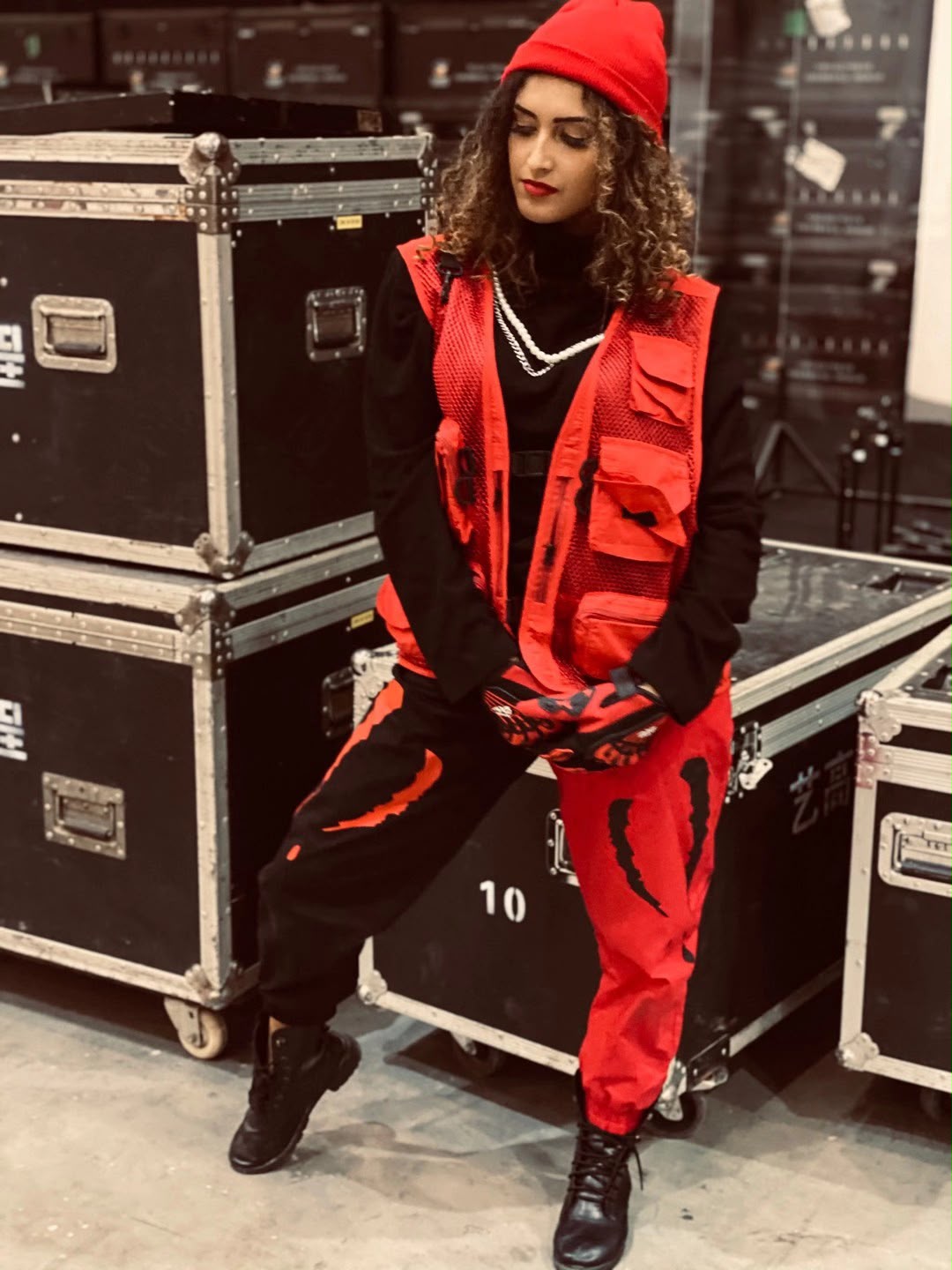 Grazi backstage in a red performance costume