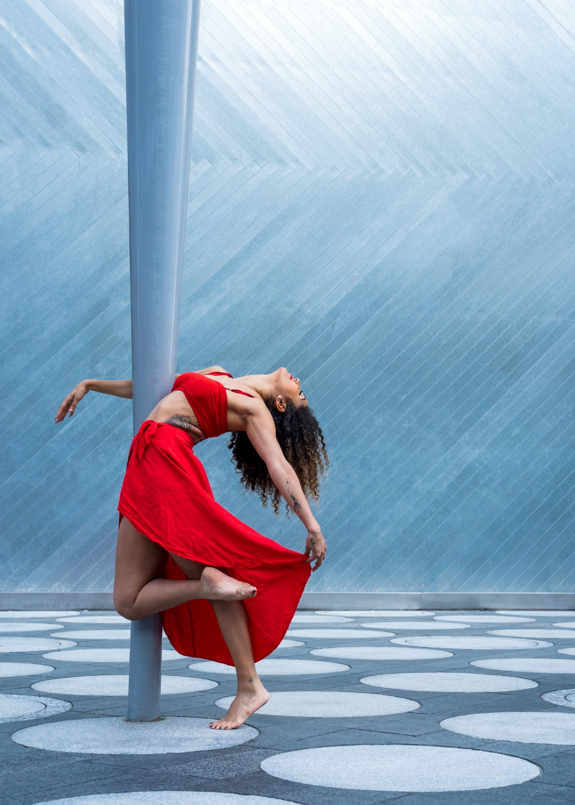 Grazi performing contemporary dance in a red costume