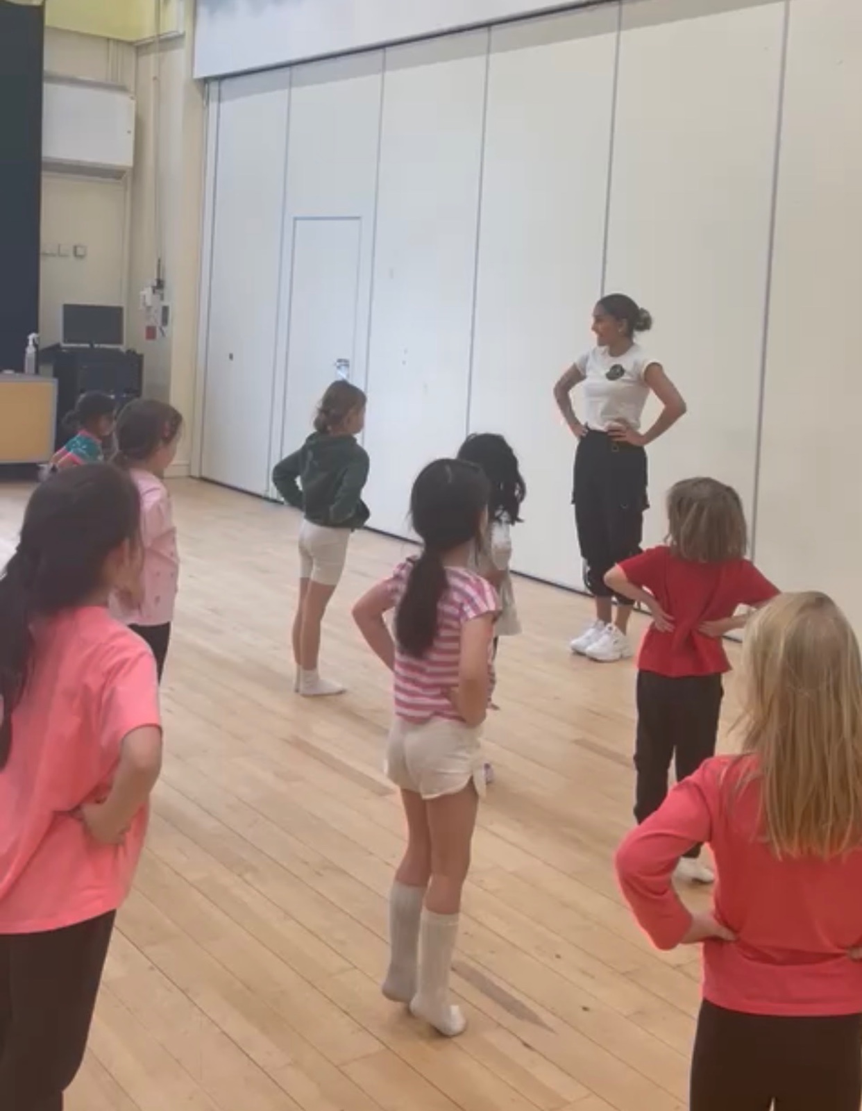 Grazi leading a children's dance class